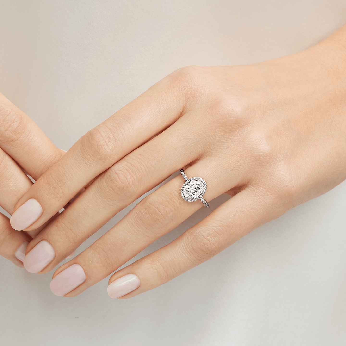 The One Oval-Shaped Diamond Micropavé Engagement Ring featured on a model